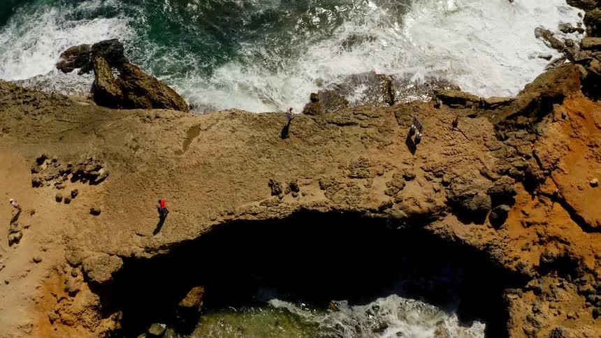 Aerial view of tourists visiting the surface of a sea cave