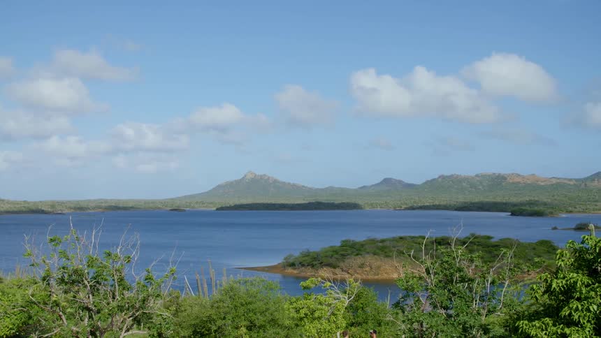 Landscape view of a lake and the shore with hills in the far distance