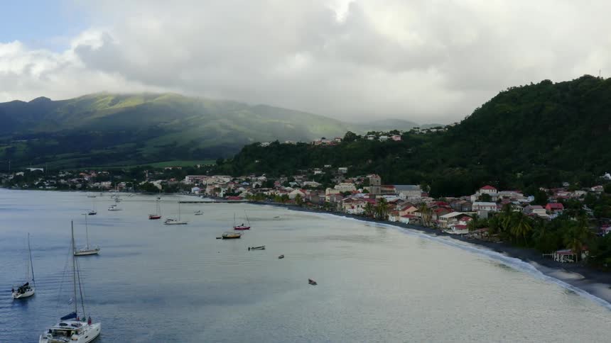 Drone shot of a port with foggy mountains