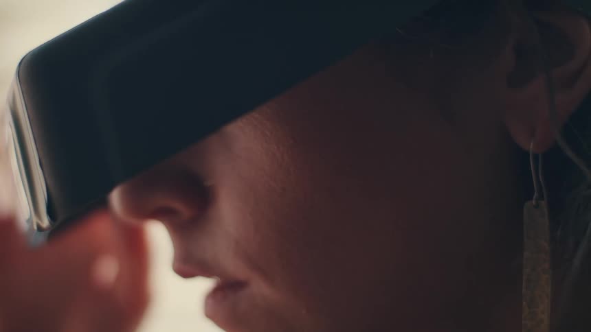 Woman pulls down magnifying eye wear