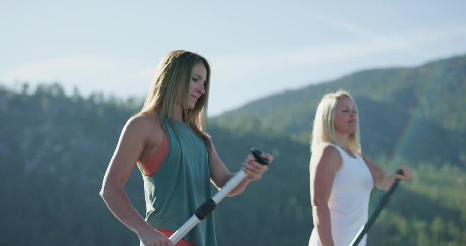 Two women paddle boarding