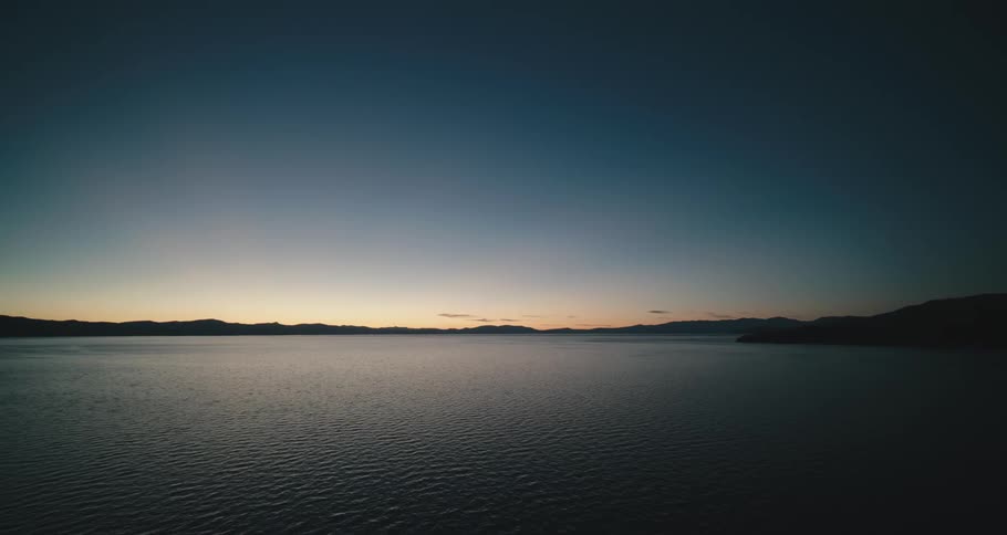 The sun is setting on the lake