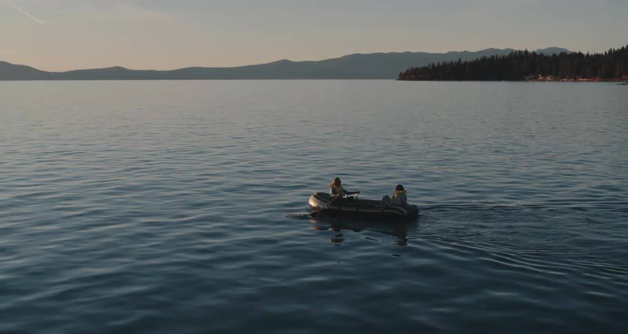 Two people in a row boat on a lake