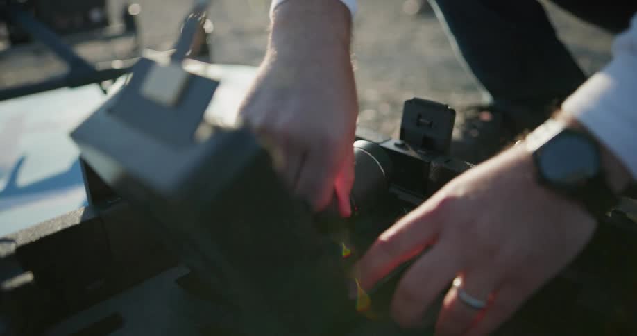 A man getting a lens out of a case