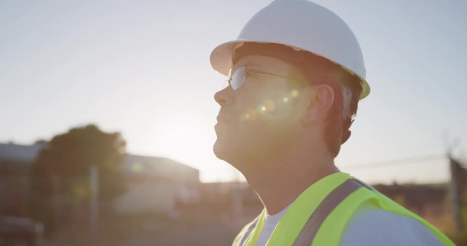 A construction worker looks up at a work site