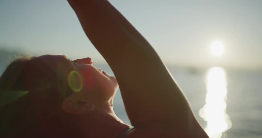 A woman doing yoga on the beach