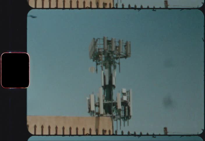 A large antenna array sits on the roof of a building