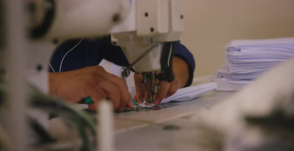 A woman sewing in a factory