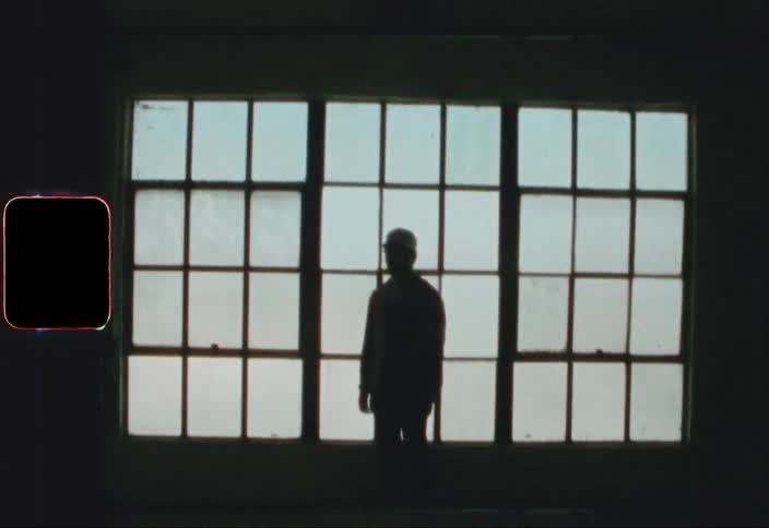 A person is standing in the dark room