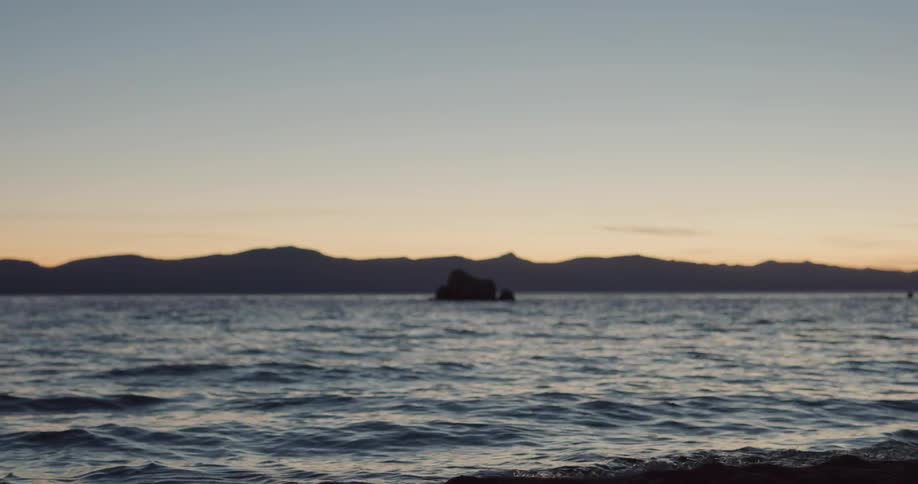 The sun is setting above the ocean water