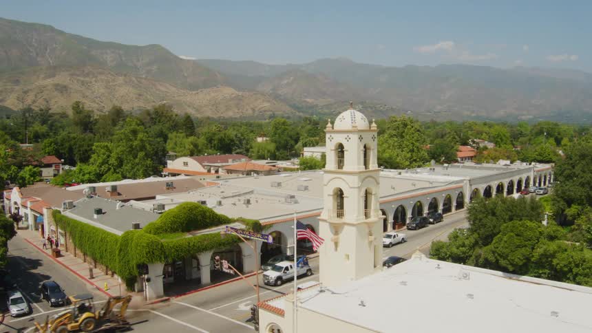 Aerial view of a tower in the center of a small town near the mountains