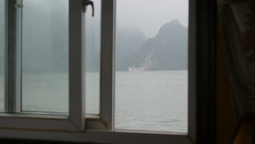 The sea seen from the window a boat traveling across in in thick fog