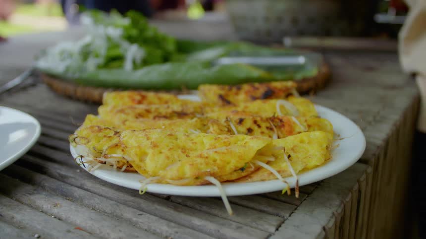 A plate of cooked food sitting on a wood table