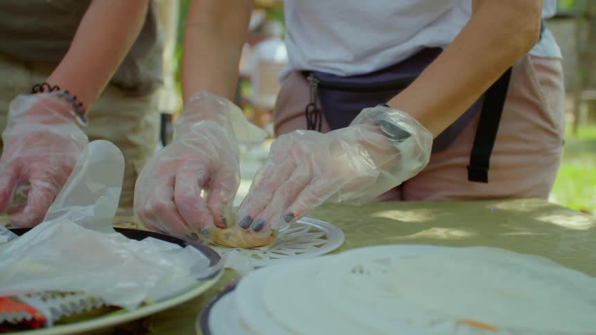People outside on a table preparing tacos