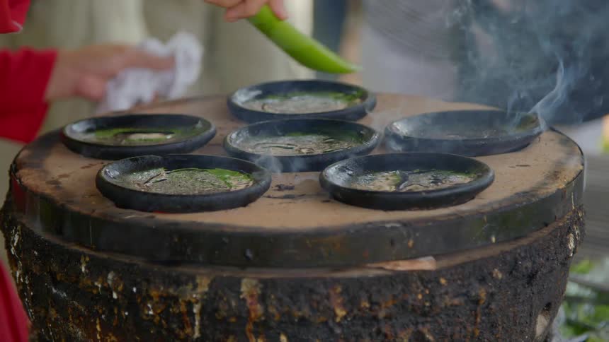 A woman cooking many small bowls of food