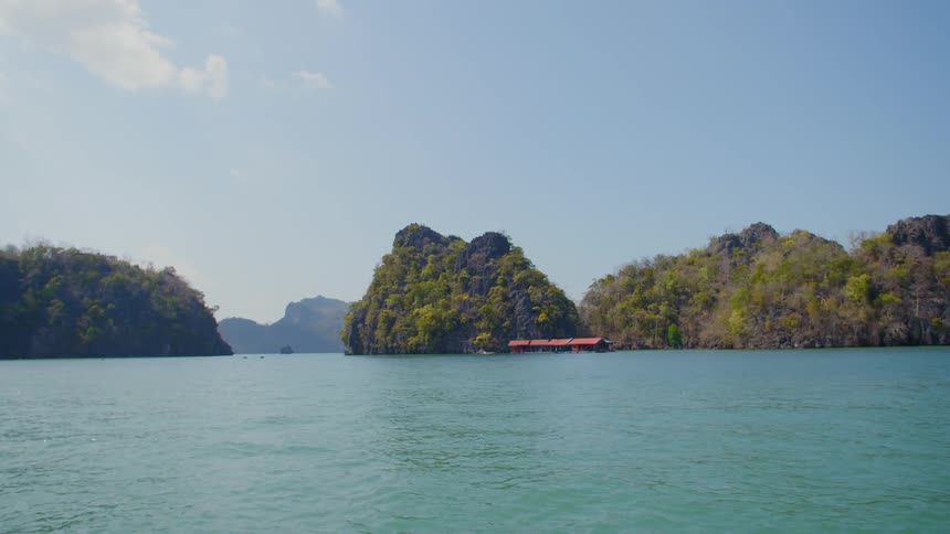 Large rock formations are in the water