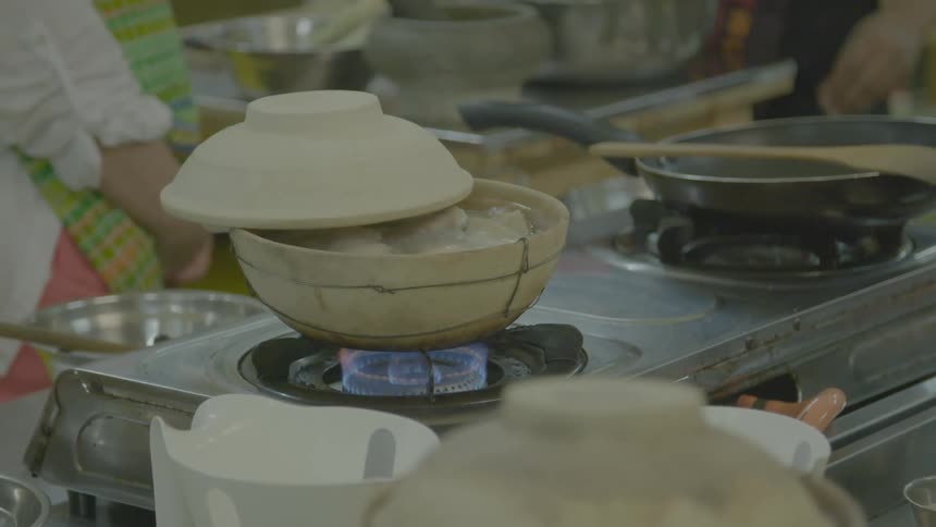 People cooking at a market