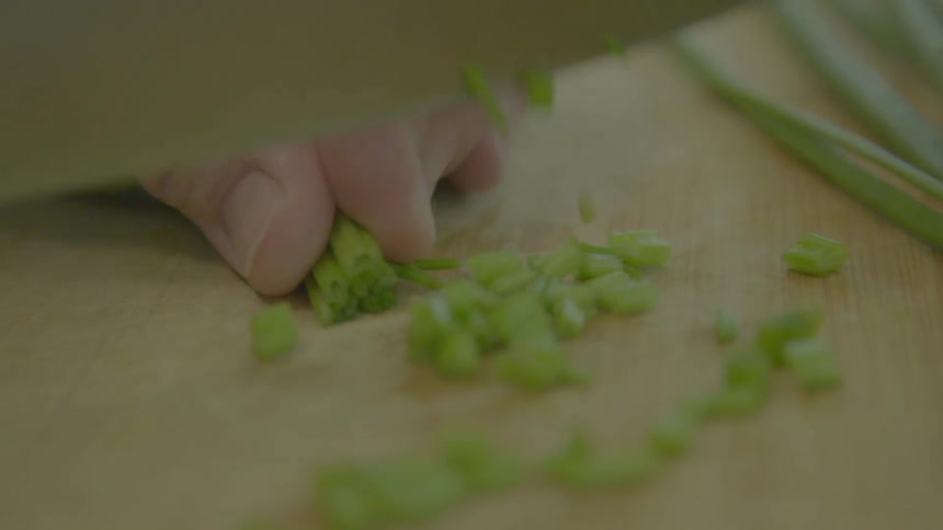 A woman chopping vegetables at home