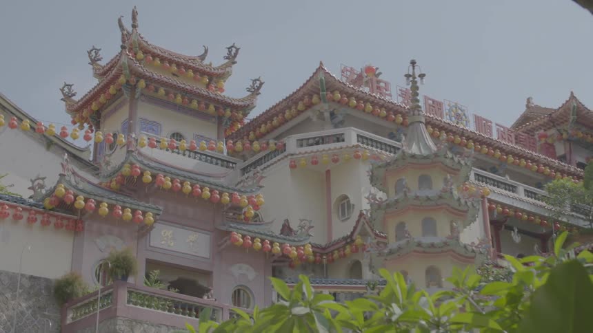 Chinese lanterns hanging from an asian building on a sunny day