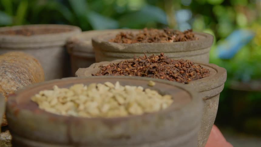 Pots of nuts seeds and spices at an outdoor market