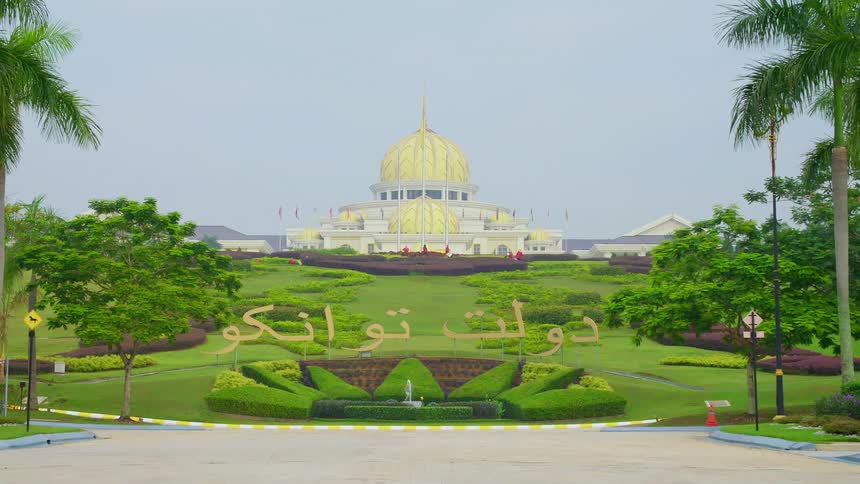 A bird flies over the fountain by the domed building