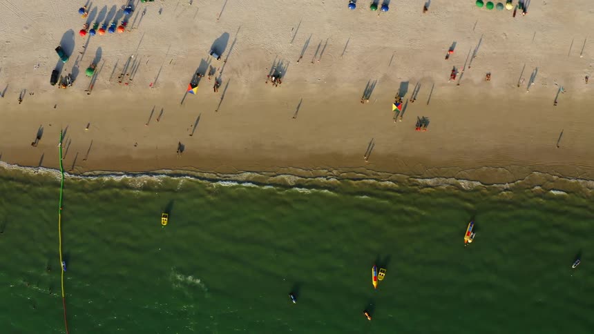 People relaxing and playing on the beach during the day