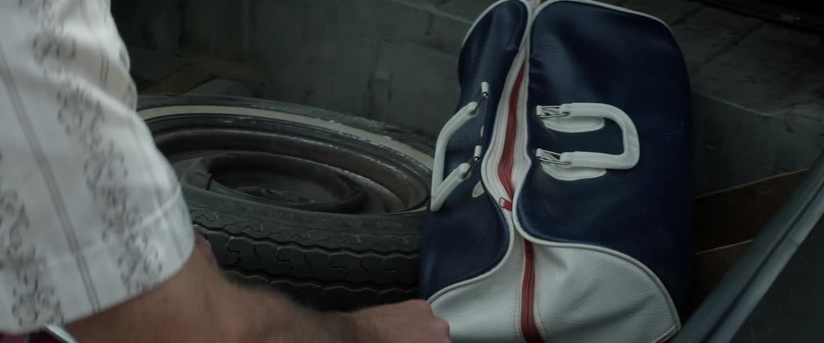 A man is looking in his trunk
