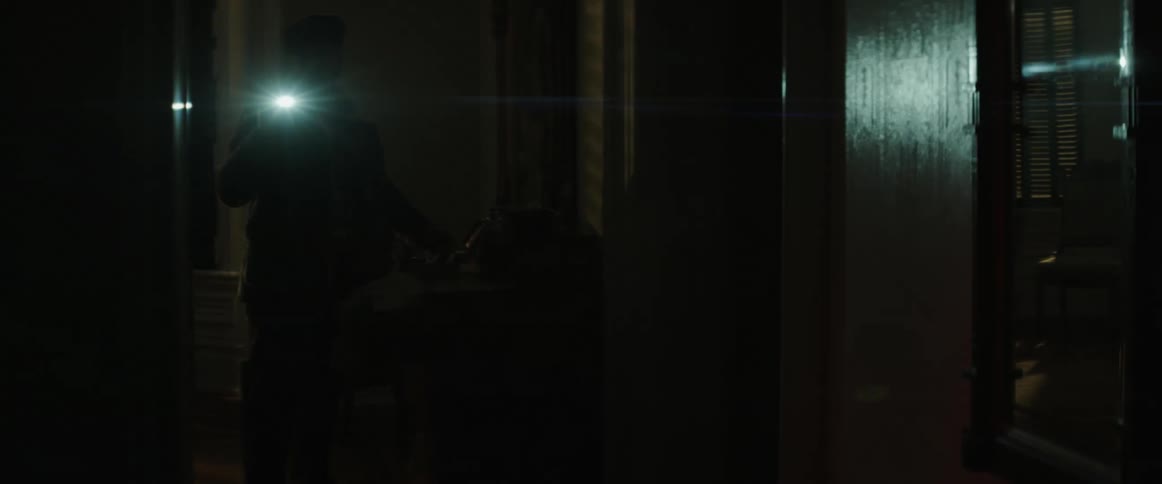 A thief rummaging through a jewelry box in the dark