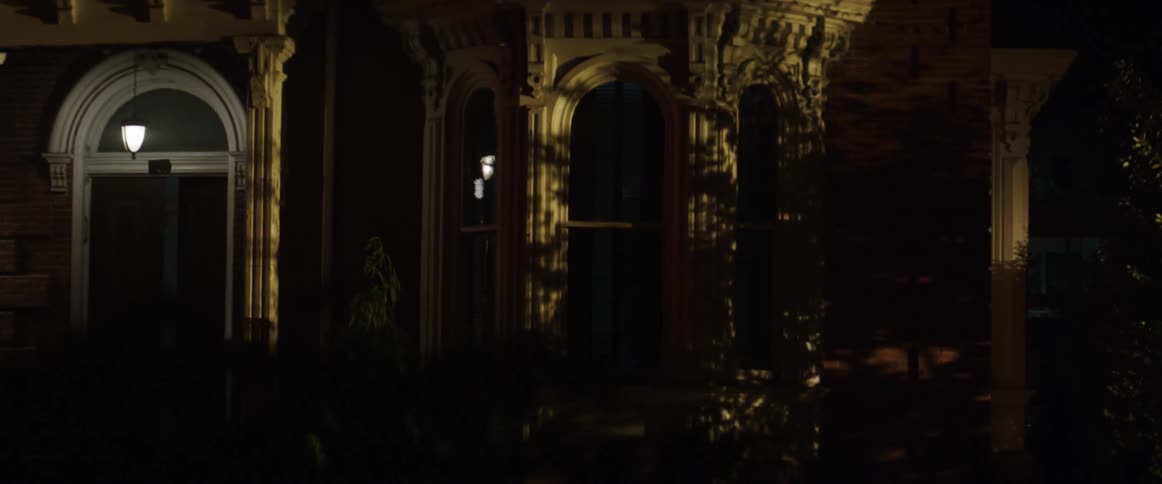 Lights flashing through a building window at night