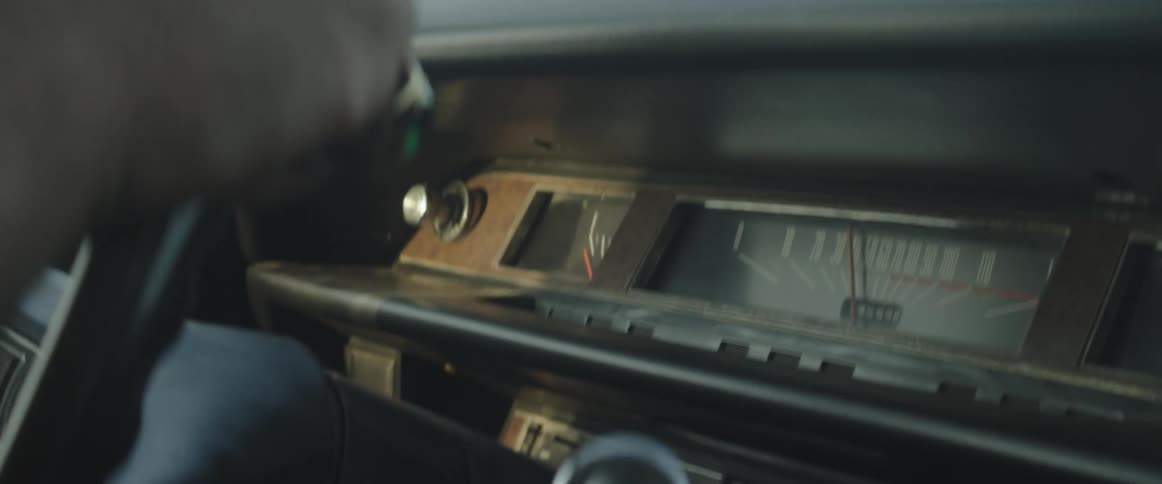 A person with a ring driving a vehicle and holding the steering wheel with their hands