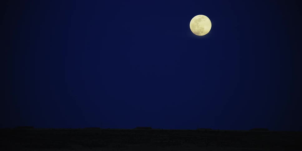 Full moon shines in the sky at night