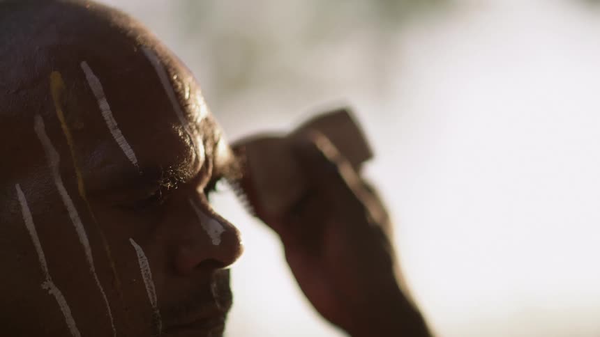 A man standing with paint on his face