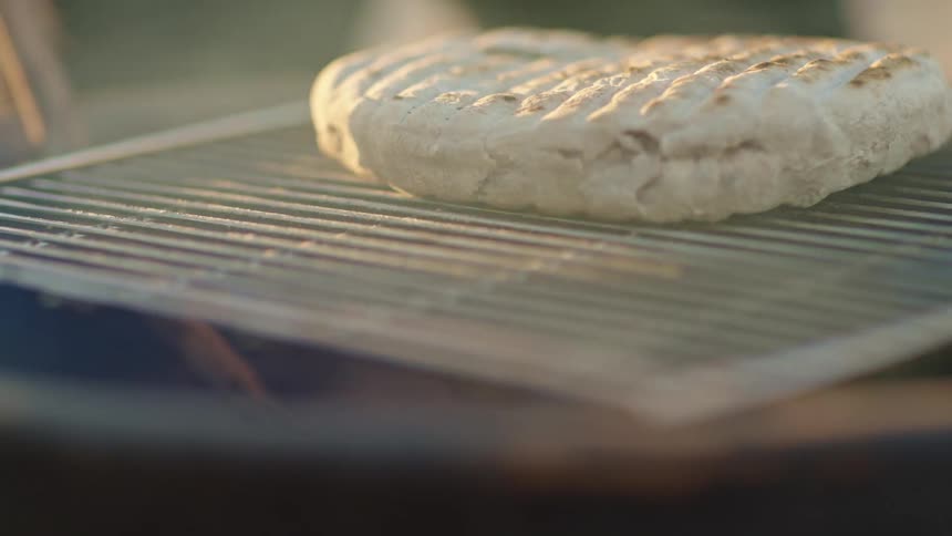 Smoke floating by food cooking on a grill