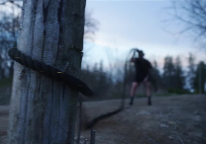 A male using a rope to exercise outdoors
