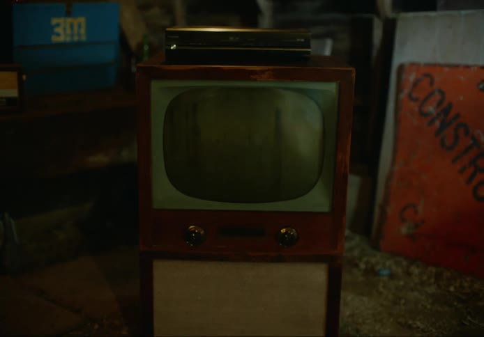 An old television and video player in a home