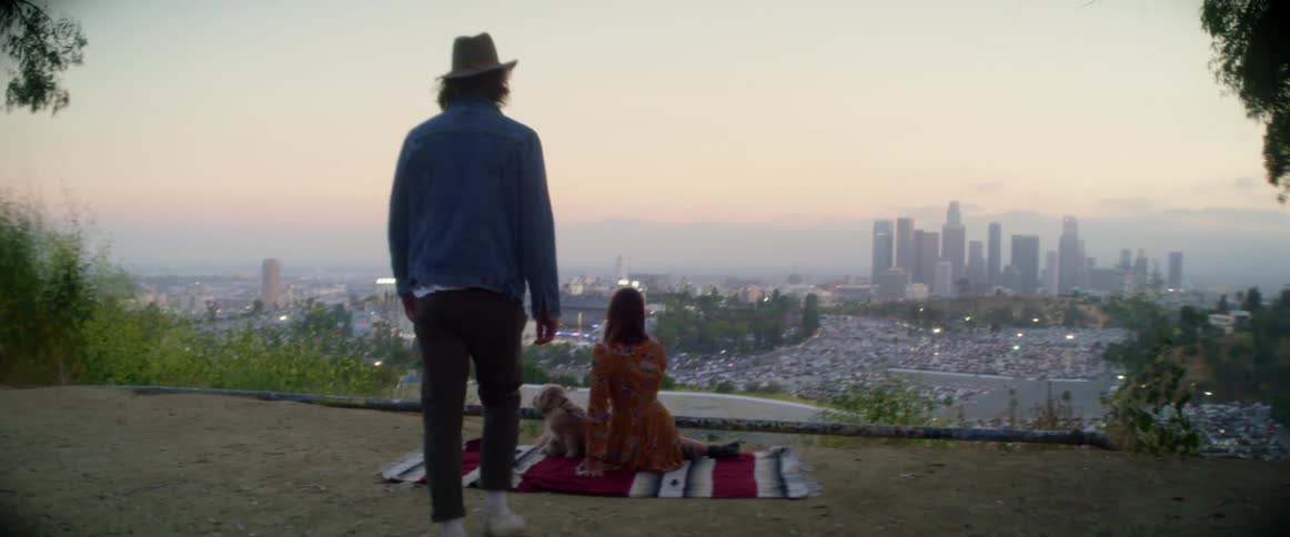 A couple have a picnic on the hill