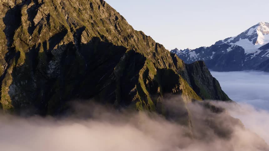 Flying over mountains above clouds