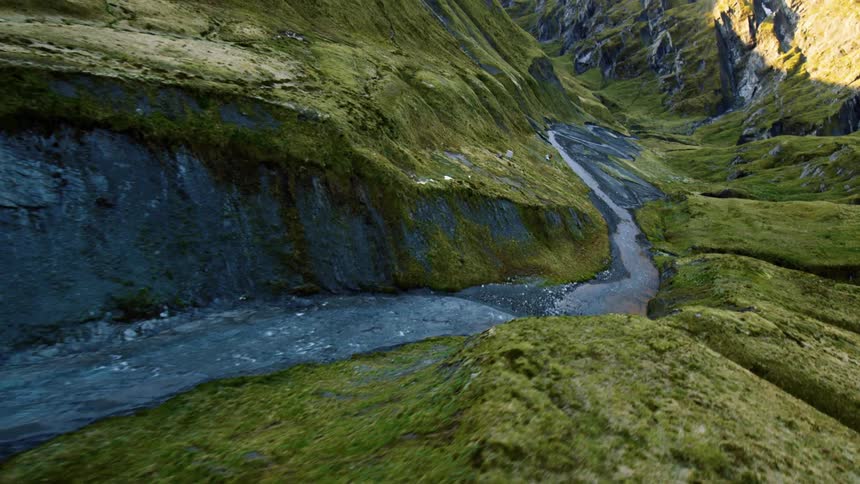 Flying over a river that is going through a canyon