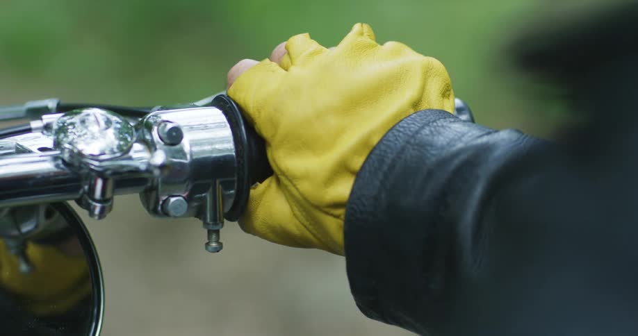 A person is turning the throttle on the motorcycle