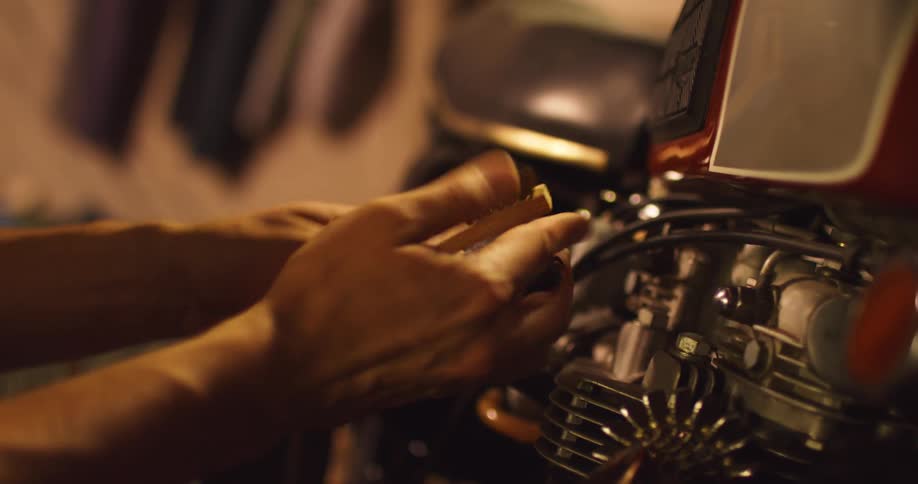 A person is working on a motorcycle engine