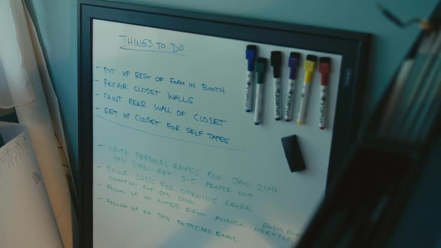 A white board has a to do list written on it