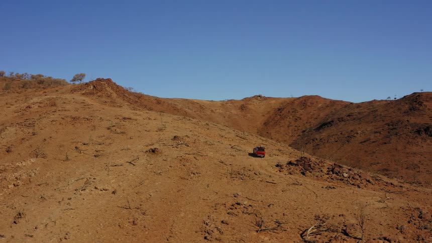 A car is driving in a rural area
