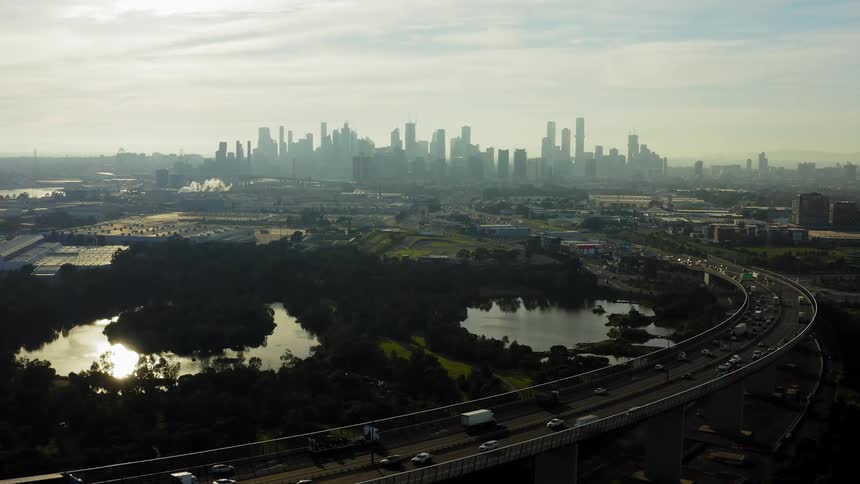 Traffic is heavy on the interstate both entering and leaving a downtown city in the morning