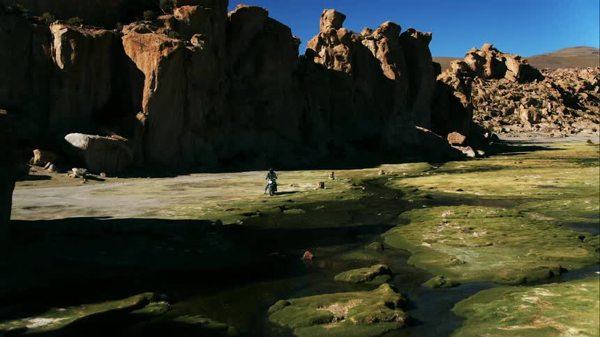 A motorcycle stops in the canyons