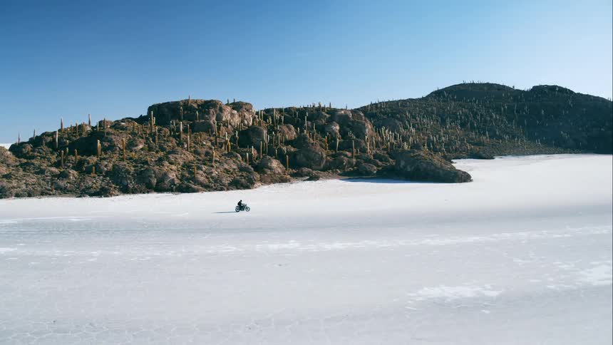 A motorcycle races on the ice covered field