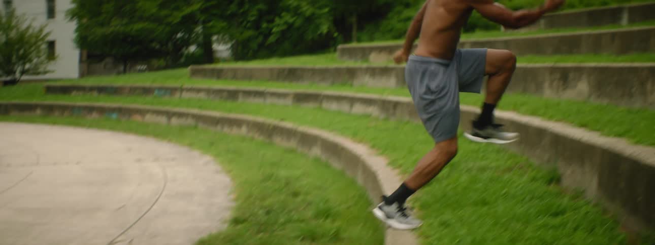 A man leaps from a path and runs up the stone wall levels