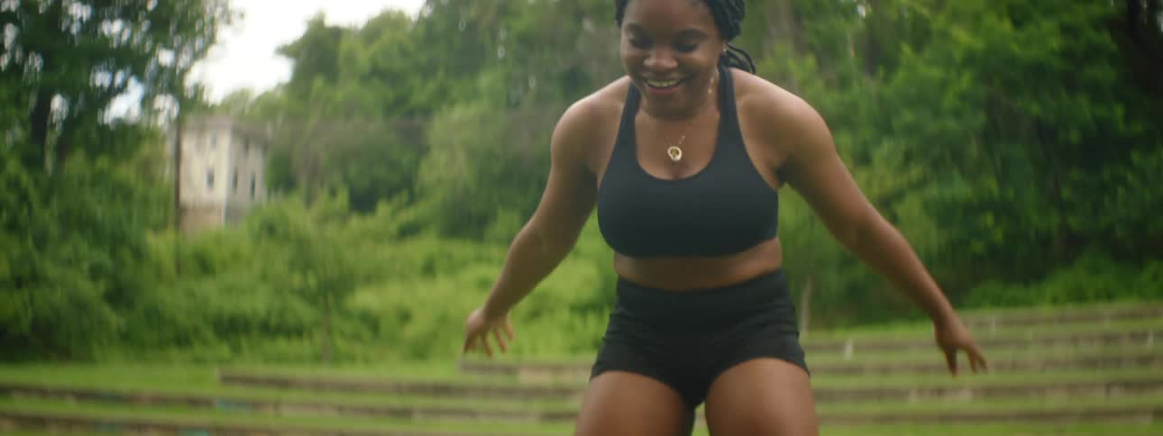 A woman does exercises with an exercise ball before stopping to take a rest