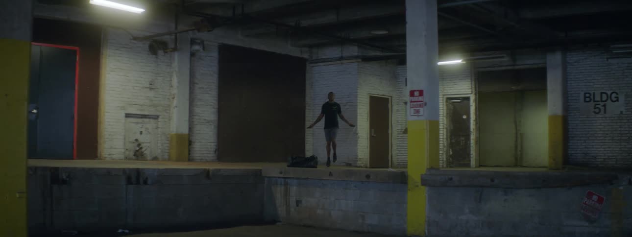 A man is jumping rope on the loading dock