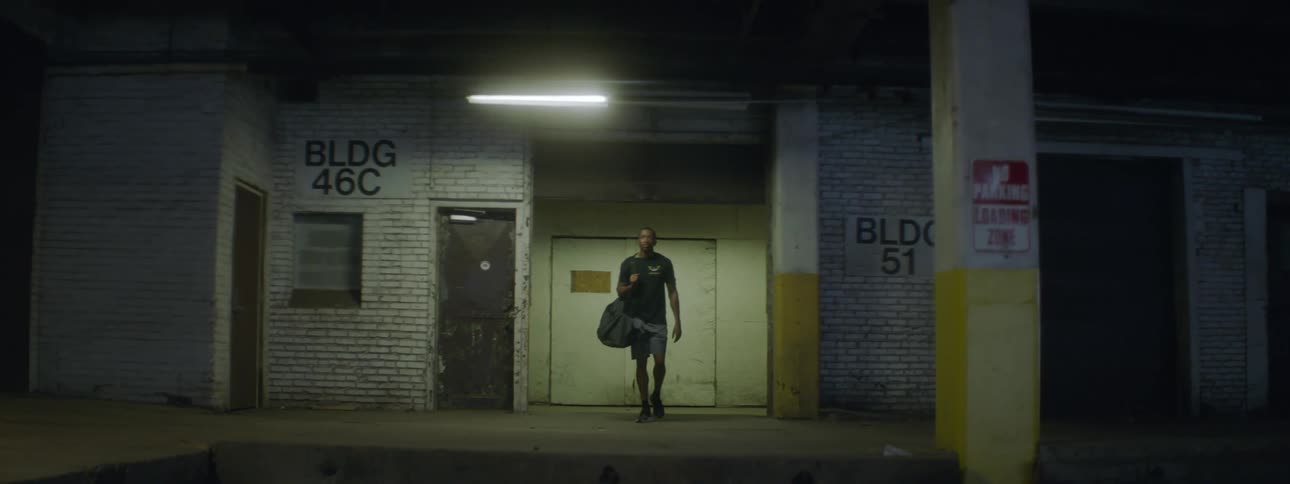 A male walking out of a business at night