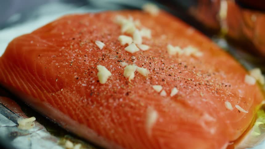 Garlic falling on salmon